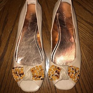 Gently worn soft peach open-toe sandal with bow